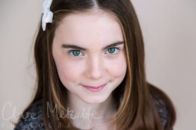 8 year old girl with green eyes smiling 
