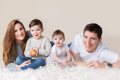 Family sitting on floor smiling