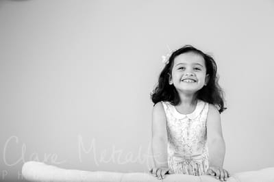 Black and white image of young girl grinning