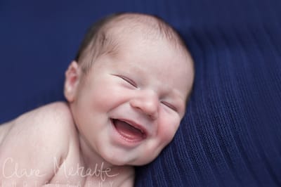 Close up of newborn baby smiling