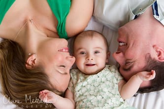 Baby with parents lying down