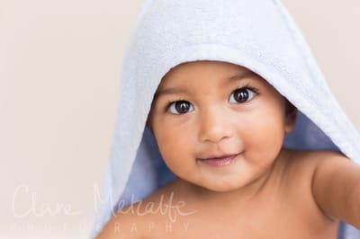 Baby smiling in hooded towel