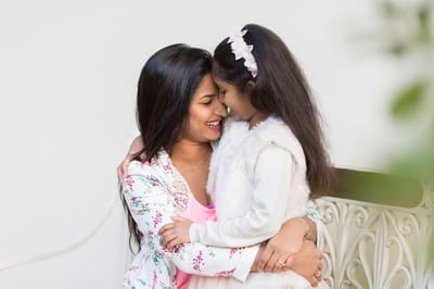 Photograph of indian mother and daughter embracing. 