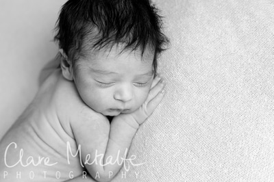Black and white close up image of newborn baby